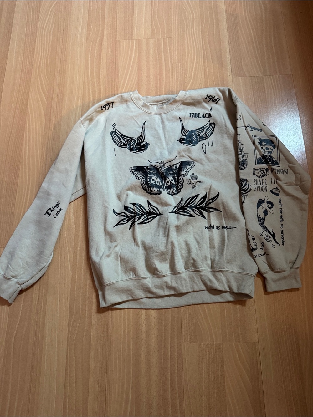 Women's Beige Graphic Crewneck Sweatshirt with Black Tattoo-Inspired Prints
